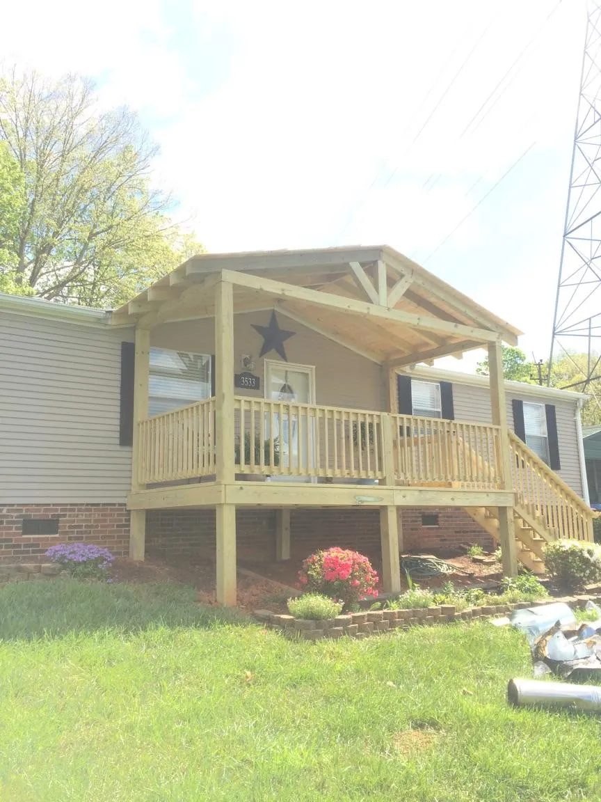 New gabled porch roof and deck railing added to a ranch home in Eaton Center